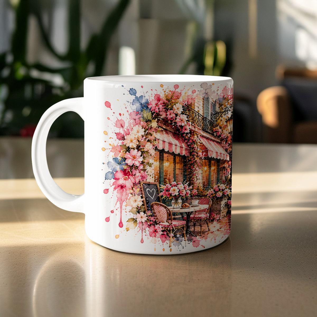 White mug with watercolor art of a Parisian cafe with flowers and outdoor seating.