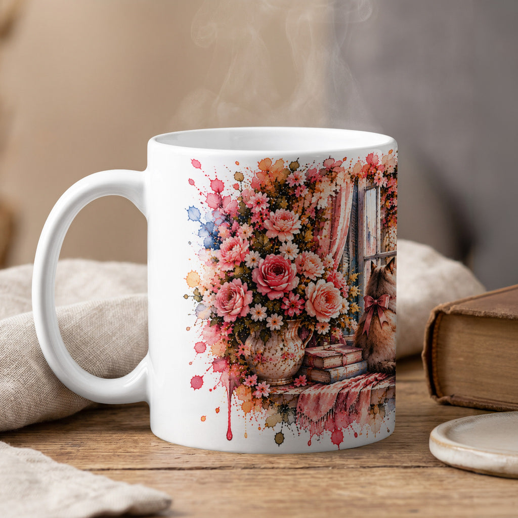 White mug with watercolor art of flowers, books, and a cat by a window.